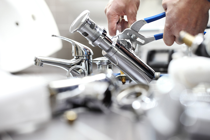 plumber fixing a bathroom sink