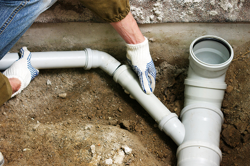 Image of a technician placing pipes